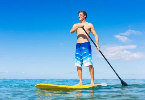 Man on stand up paddle board Stock Photos