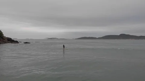 Man stand up paddle boarding on  The Beach in Buzios, Brazil. Stock Footage 125283189
