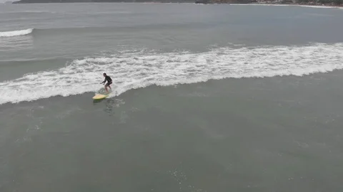 Man stand up paddle boarding on  The Beach in Buzios, Brazil. Видео 125283201