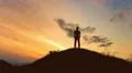 The man stand on the rock on the background of sunset. Real time 4k or 4k+ Resolution