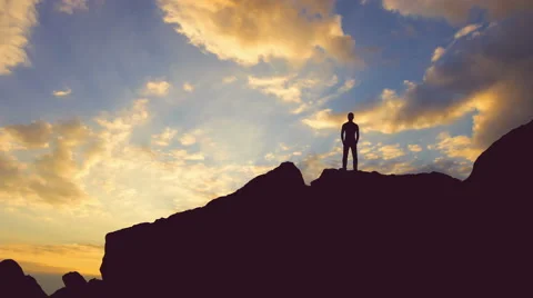 The man stand on the rock on the background of sunset. Time lapse Stock-Footage 64267243