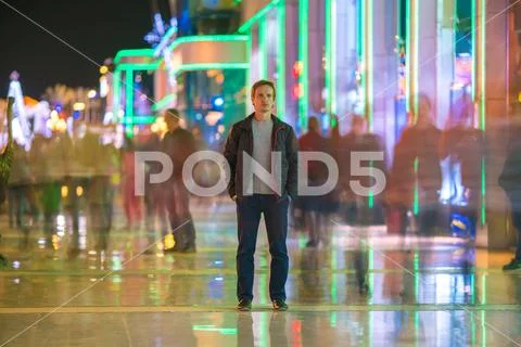 The man stand in the smash crowd stream. Evening night time Stock Photos