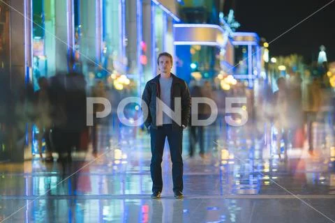 The man stand in the smash ghost crowd stream. Evening night time Stock Photos
