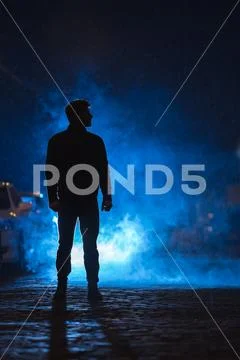 The man stand on the smoky street. Evening night time Stock Photos
