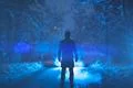 The man stand on a snowy road on the background of a smoke. evening night tim Photo