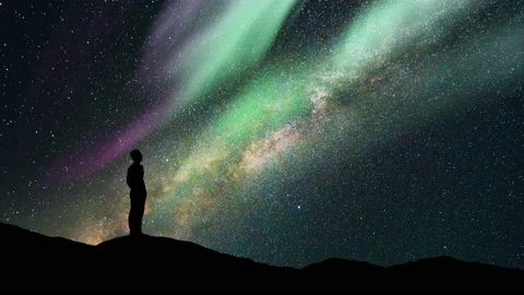 The man stand on a starry sky background with a polar light. time lapse Stock Footage 160124894