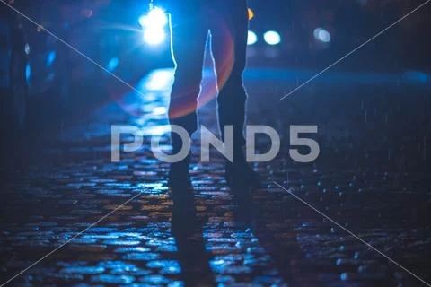 The man stand on the stone road. Evening night time. Telephoto lens shot Stock Photos