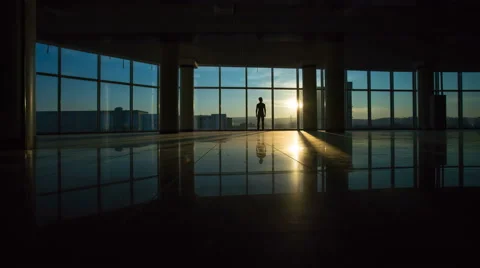 The man stand by the window on the sunset background. Time lapse, wide angle Stock Footage