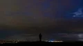 The man standing above the city with a lightning. time lapse 4k or 4k+ Resolution