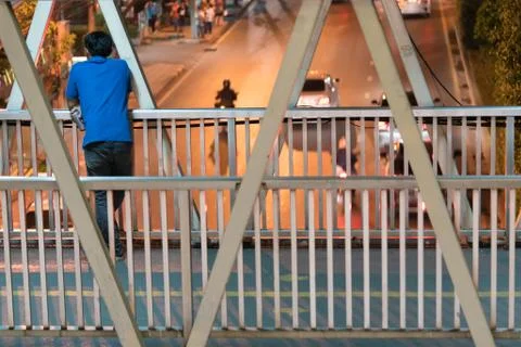 Man standing alone on the bridge. 스톡 사진