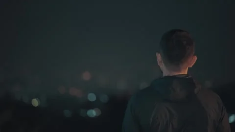 Man Standing Alone with City Lights at Night 스톡 동영상 331922462