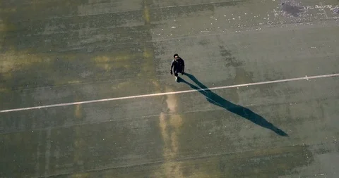 Man standing alone in empty stadium ground. Stock Footage 92240960