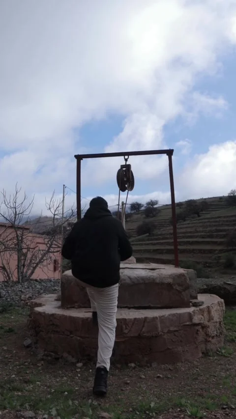Man Standing by Ancient Stone Well in Berber Village, Tiznit Morocco 스톡 동영상 332769365