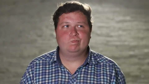 Man standing and chewing in evening outdoor Stock Footage 101393168