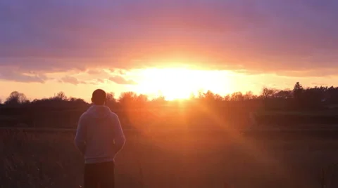 Man standing and looking at the sunset Stock Footage 60050253