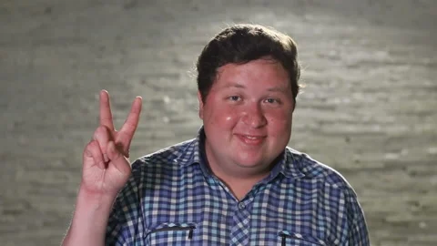 Man standing and making v sign in evening outdoor, portrait Stock Footage 101394689