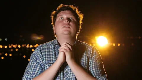Man standing and praying at night outdoor, portrait Stock Footage 101397822