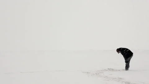 Man Standing and then Collapsing During a Blizzard Stock Footage 162257119