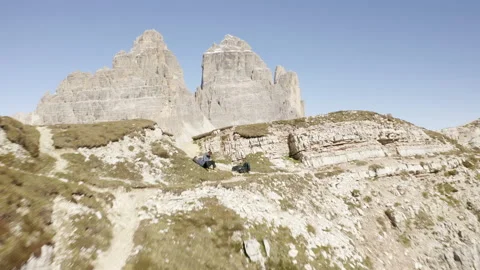Man standing and walking on mountain ridge epic drone view dolomites Stock Footage 143368825