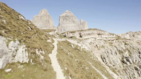 Man standing and walking on mountain ridge epic drone view dolomites Stock Footage 143368957