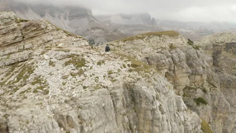 Man standing and walking on mountain ridge epic drone view dolomites Stock Footage 143369482