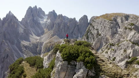 Man standing and walking on mountain ridge epic drone view dolomites Stock Footage 143369772