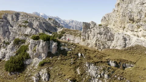 Man standing and walking on mountain ridge epic drone view dolomites Stock Footage 143370667