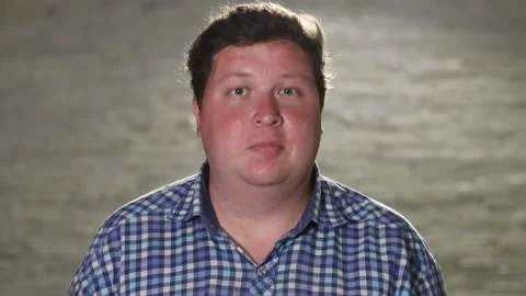 Man standing and winking at camera in evening outdoor Stock Footage 99607935