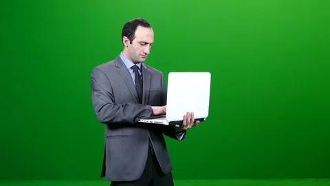 Man Standing and Working on a Laptop Green Screen 動画素材 83735156