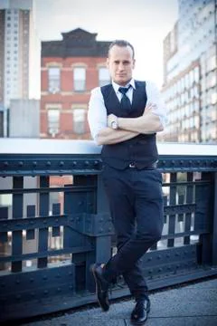 Man standing with arms folded, full length portrait Stock Photos