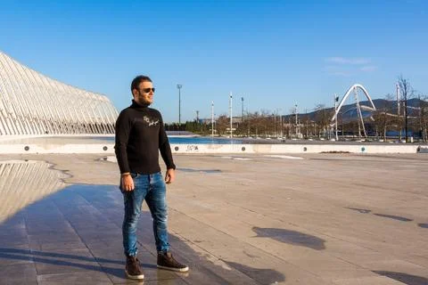Man standing at Athens Olympic Complex with Calatrava architecture, Greece. Stock Photos