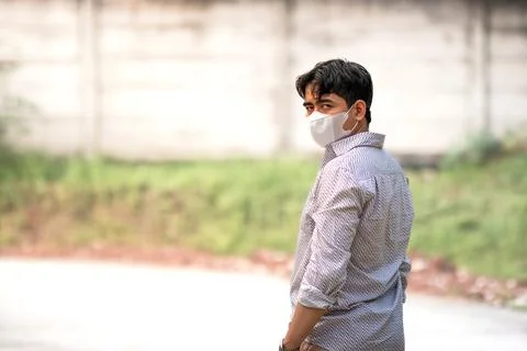 Man standing back and looking at camera with his mask. Wearing mask as a fa.. Stock Photos