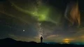 The man standing on a background of the city with a northern light. time lapse 4k or 4k+ Resolution
