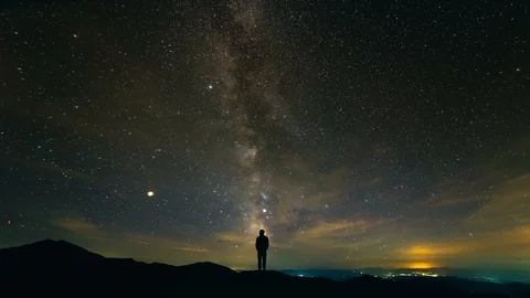 The man standing on the background of the starry sky above the city. time lapse Stock Footage 96303643