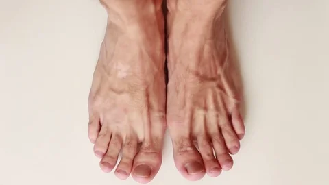 Man standing barefoot on white surface Stock Footage 79343730