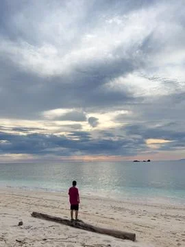 Man Standing on Beach Looking at Ocean Stock Photos