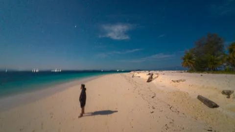 Man Standing on Beach at Night 写真素材