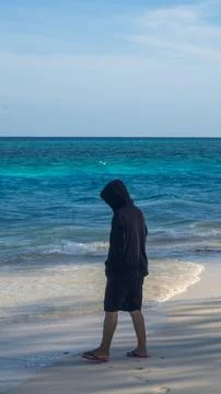Man Standing on Beach by Ocean Фото