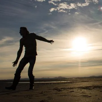 Man standing on beach Stock Photos