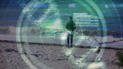 Man standing on beach, using data rings and network lines with floating code Stock Footage 309096875