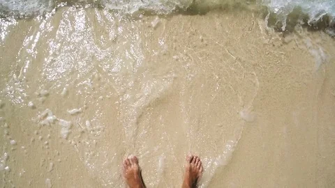 A man standing on the beach. white sand and clear water. first-person view Video stock 72414534