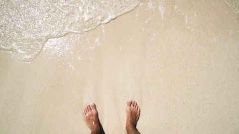 A man standing on the beach. white sand and clear water. first-person view Stock Footage 72414899