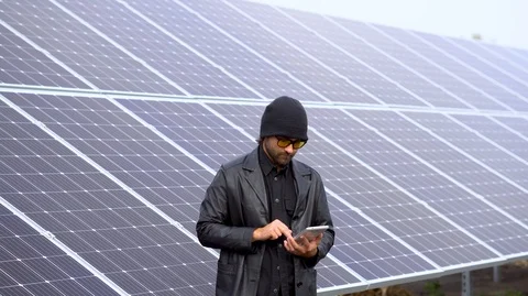 Man standing beside of solar panels, working on tablet Stock Footage 126552753