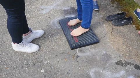 Man standing on a board with nails, after which it goes Stock Footage 68348663