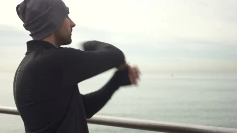 Man standing on the bridge stretching arms before workout Stock Footage 132040913