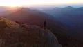 The man standing on the cliff and enjoying the sunrise 4k or 4k+ Resolution