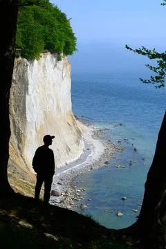 Man standing on the cliff of the chalk cliffs in the national park, Germany Stock Photos