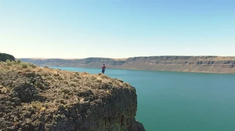 Man standing on a cliff Stock Footage 65968219