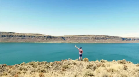 Man standing on a cliff Stock Footage 65968385