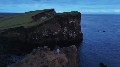 Man Standing on Cliff by the Ocean Stock Footage 320699814